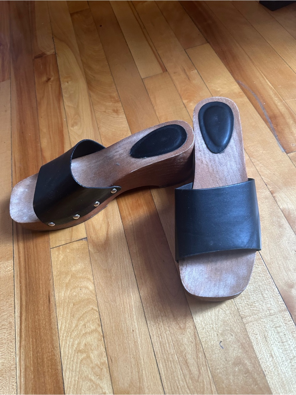 Black leather wooden clogs